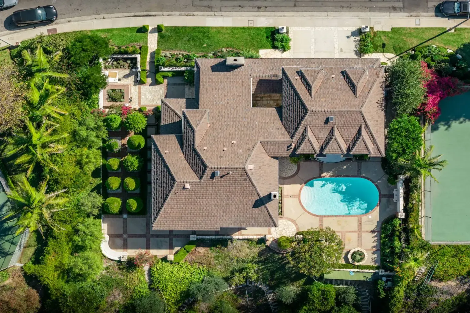 Aerial view of a home, pool and gardens