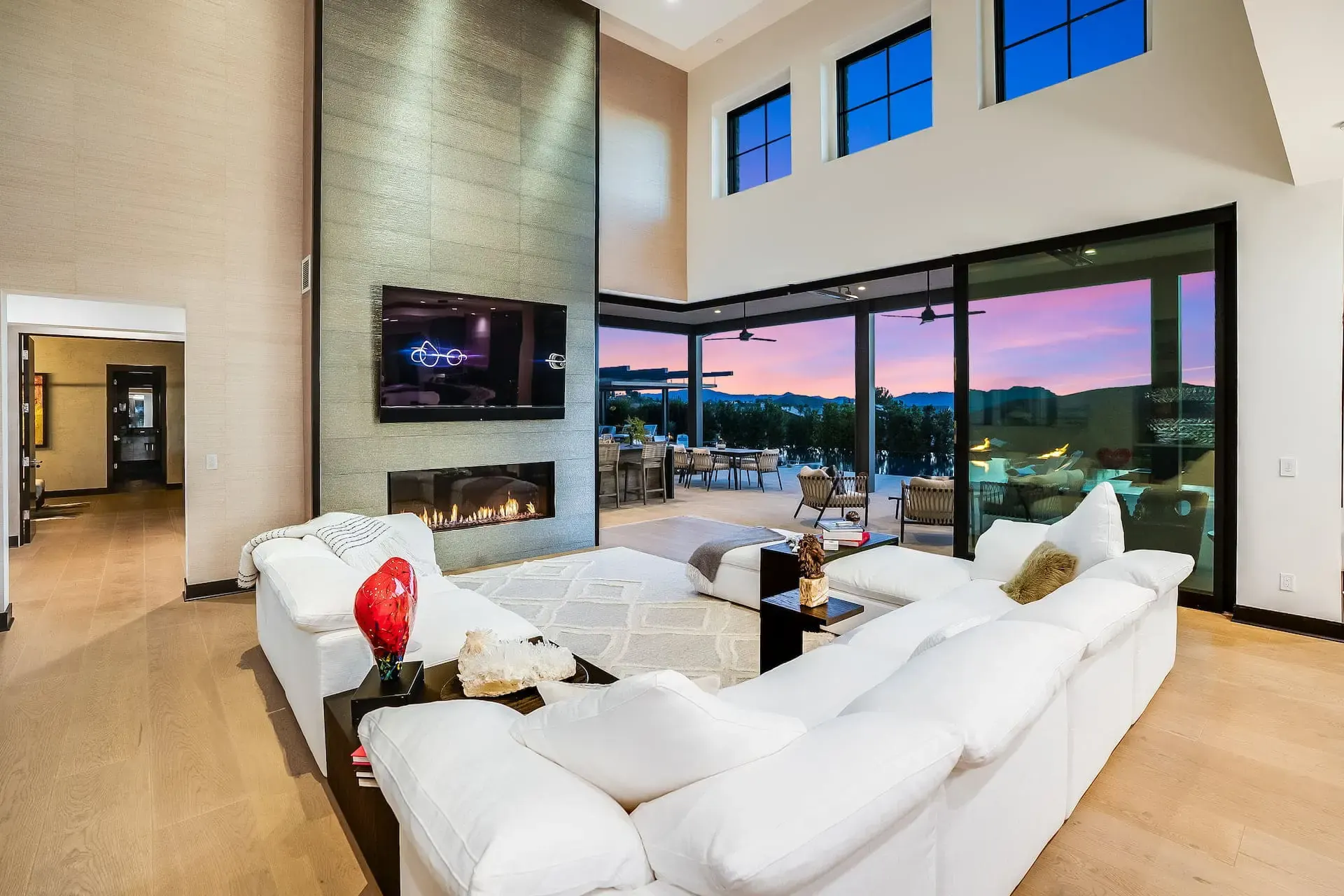 Open living room with fireplace at dusk